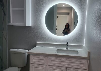 A modern bathroom with mirror & cupboard